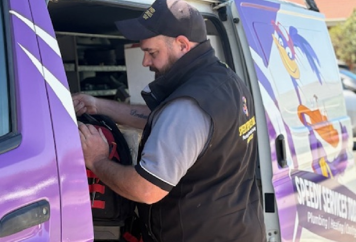 Daniel out of his Plumbing, Evaporative Cooling and Ducted Heating Service Van.